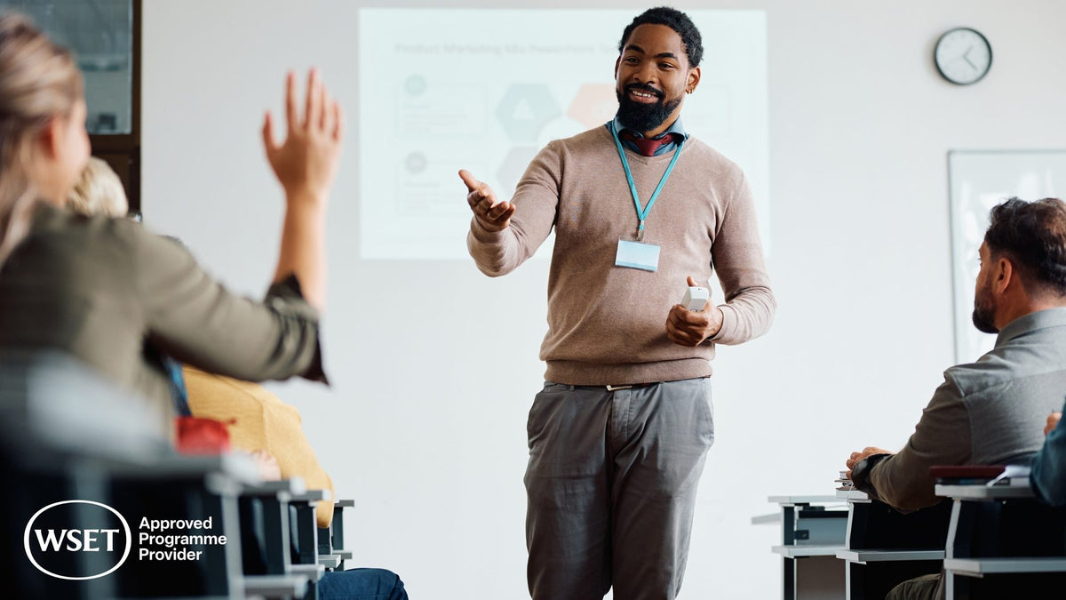 WSET educator engaging with students in a bright interactive classroom